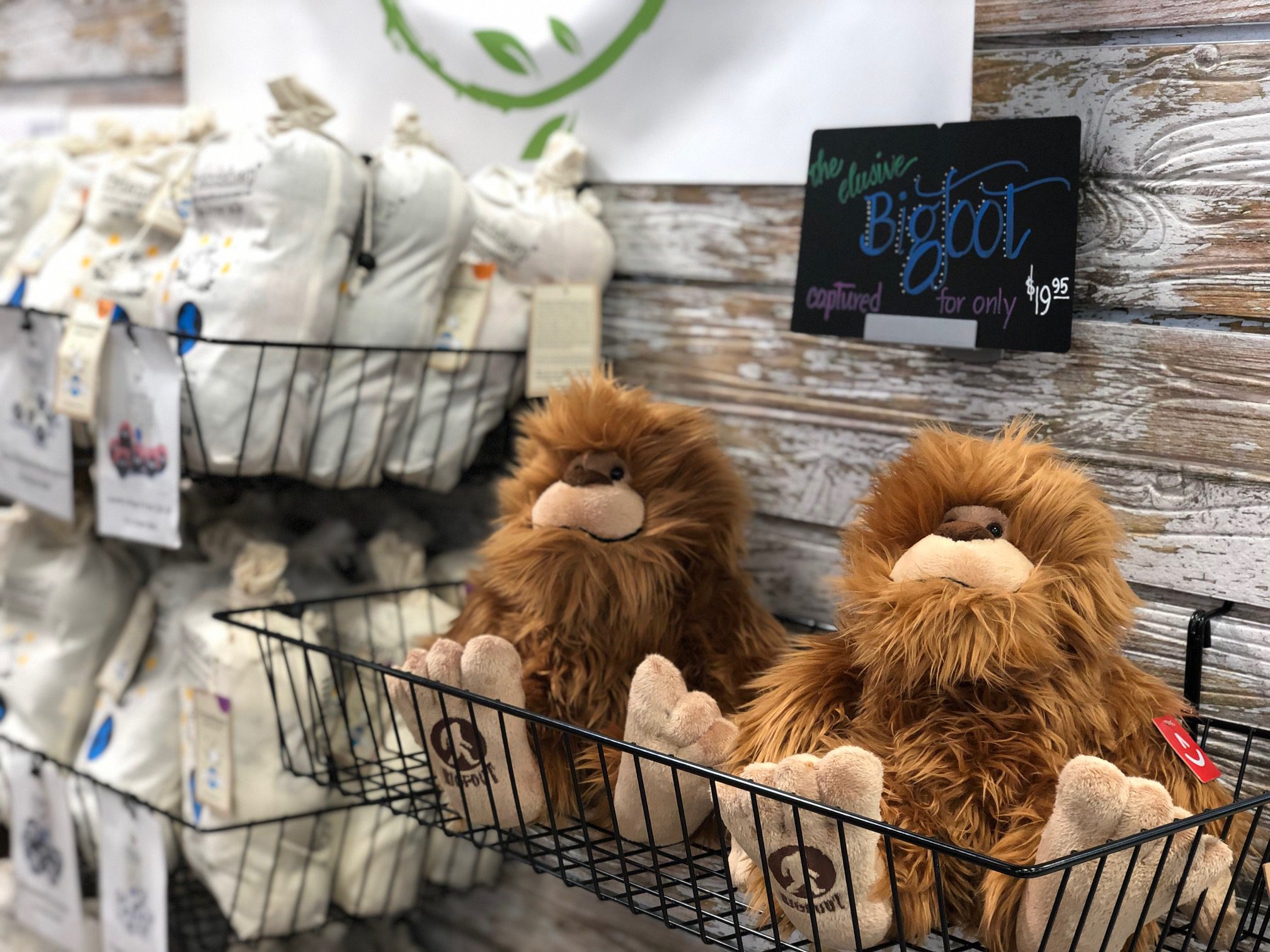 Two Bigfoot stuffed animals in a basket.
