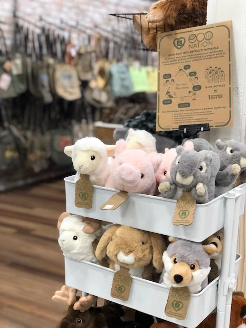 Various stuffed animals in a white cart.
