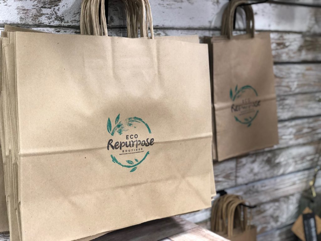 Eco Repurpose Boutique stamp on paper bags.
